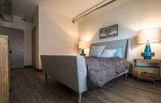 a bedroom with a bed and two lamps