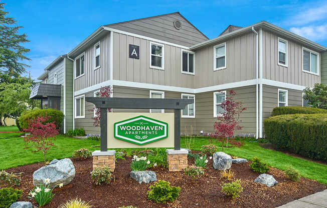 Exterior view of building and front sign with well maintained landscaping. at Woodhaven, Everett, WA