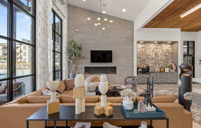 A modern living room with a fireplace and a large window. at Bridge at Tech Crossing, Austin, 78753