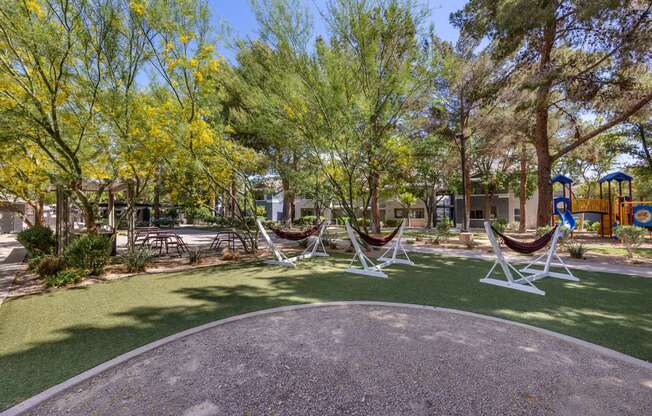 a group of hammocks in a park with a playground at Paisley and Pointe Apartments, Las Vegas, 89130