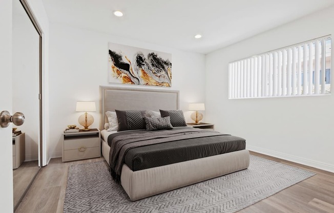 A modern bedroom with a large bed and a painting on the wall.