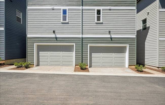 A modern two-story house with two garages.
