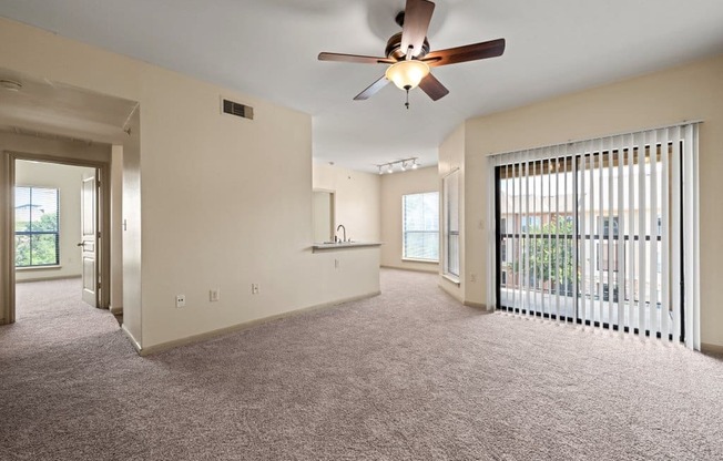 a large living room with a ceiling fan