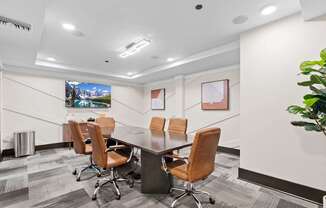 A conference room with a long table and chairs.