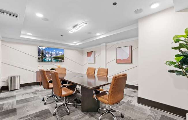 A conference room with a long table and chairs.