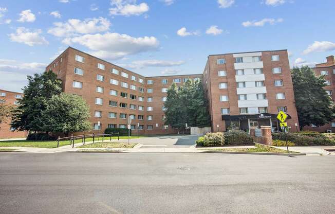 A street view of a residential area with two apartment buildings.