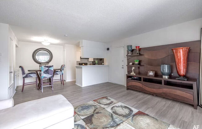 a living room with a couch and a table in a kitchen