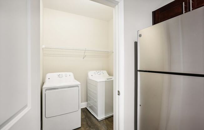 a white washer and dryer in a room with a refrigerator