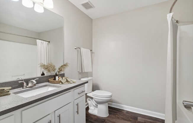 Model bedroom with white vanity at Retreat at Stonecrest Apartments