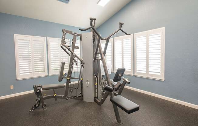 A gym with a blue wall and a white door at Zinfandel Village Apartments, California, 95670
