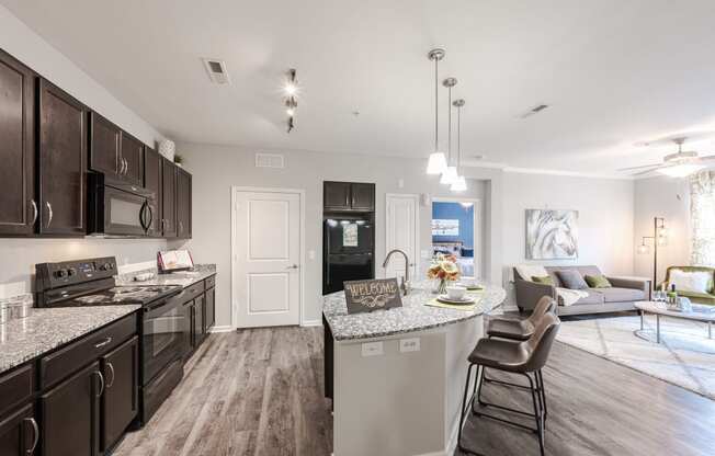 an open kitchen and living room with a large counter top