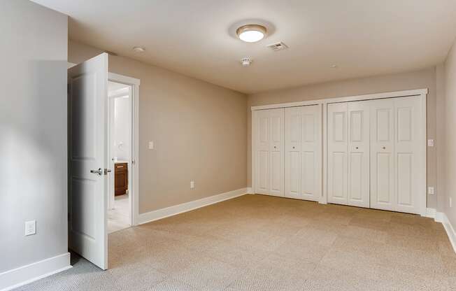 A room with a carpeted floor and a ceiling light.