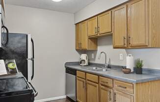 a kitchen with wooden cabinets and stainless steel appliances