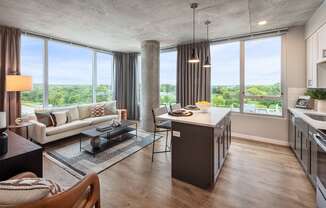 a living room and kitchen with a view of the city