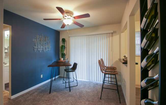 This is a photo of the dining area of the 550 square foot 1 bedroom, 1 bath, balcony floor plan model apartment at College Woods Apartments in Cincinnati, OH.