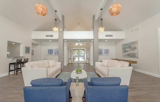 a living room with couches and chairs and a coffee table