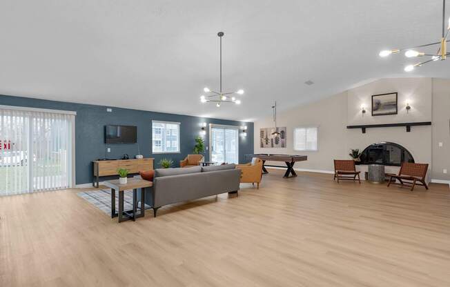 A living room with a grey couch, a wooden table, and a television.