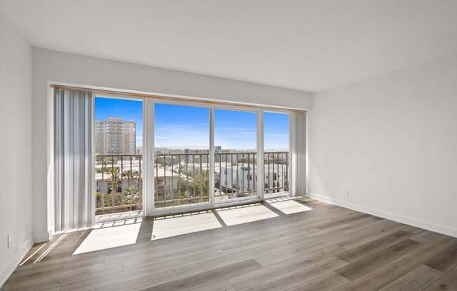 A room with a large window overlooking a cityscape.