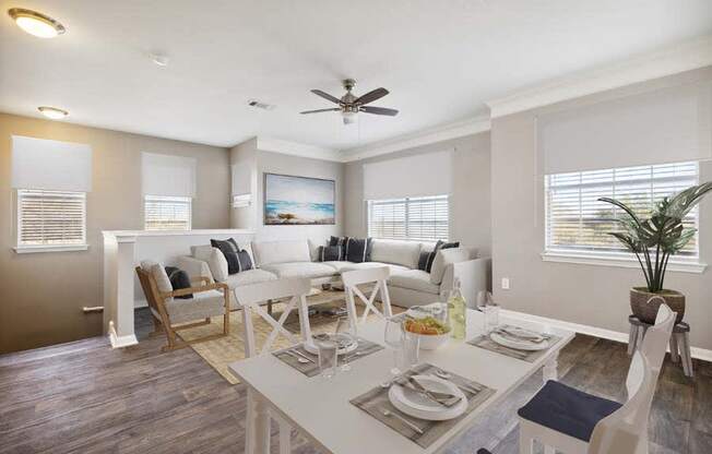 a living room filled with furniture and a ceiling fan