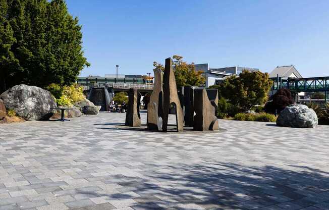 A park with a large rock and a bridge in the background at Spyglass Hill Apartments, Bremerton, 98337