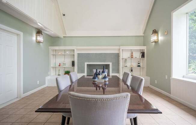A dining room with a table and chairs.