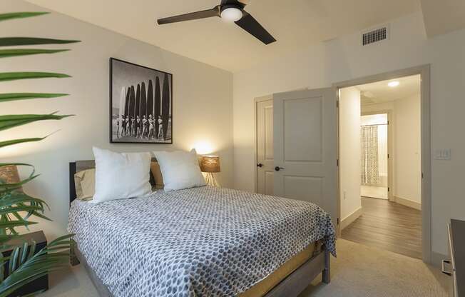 a bedroom with a bed and a ceiling fan