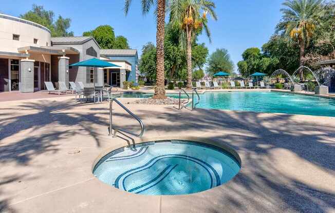 A pool with a slide and palm trees in the background.