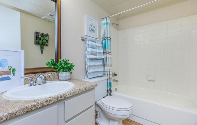 a bathroom with white cabinets
