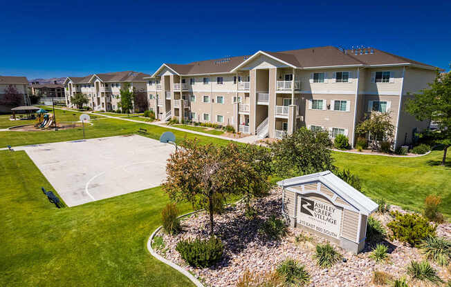 A view of a Shelby Village apartment complex with a playground and a sign.