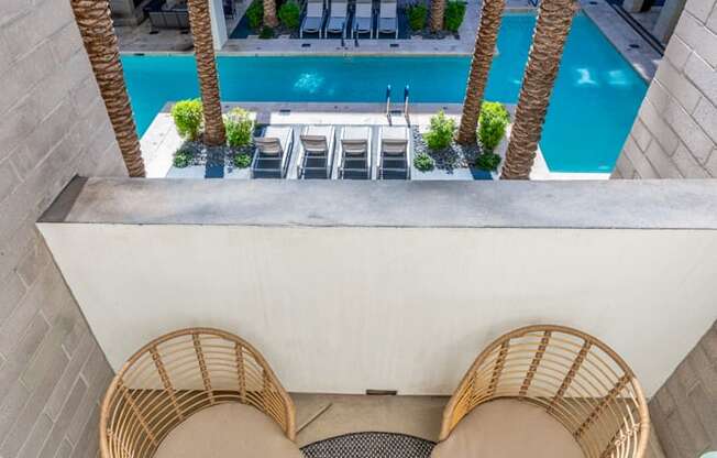 a patio with chairs and tables and a swimming pool