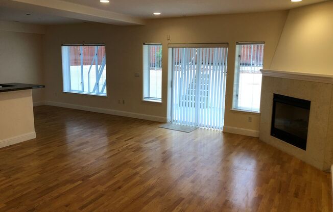 OPEN TOMORROW! Huge bi-level 3 bedroom 2.5 bath loft style apartment w/huge sunny yard, gas fireplace, remodeled kitchen, in-unit laundry and garage parking