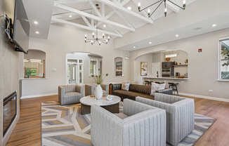 A modern living room with a grey sofa set and a wooden floor.