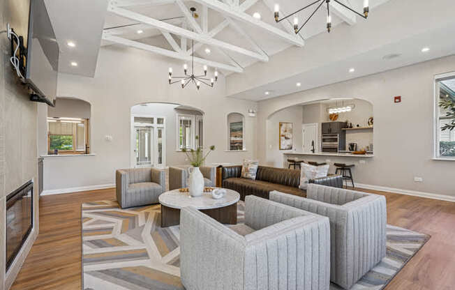 A modern living room with a grey sofa set and a wooden floor.
