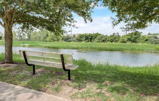 a park bench sitting next to a river