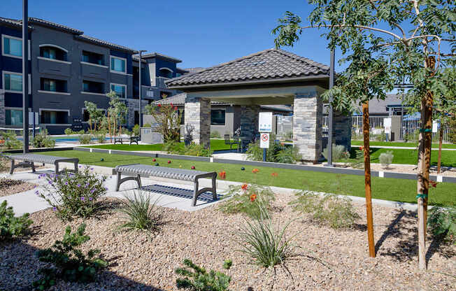 Community game area with bocce ball, benches, a ramada, BQQ area