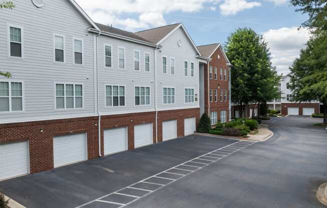 an empty parking lot in front of an apartment building