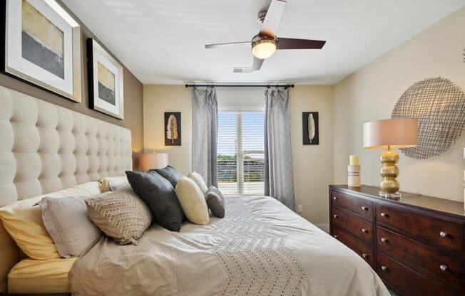 a bedroom with a large bed and a ceiling fan at Link Apartments® Brookstown, North Carolina