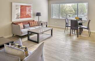 a living and dining room area with a couch table and chairs and a large window  at 3030 Lake City, Seattle, 98125