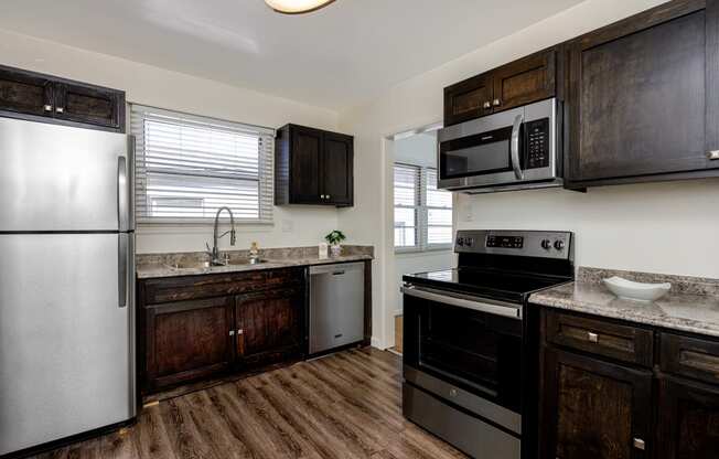 a kitchen with stainless steel appliances and wooden cabinets