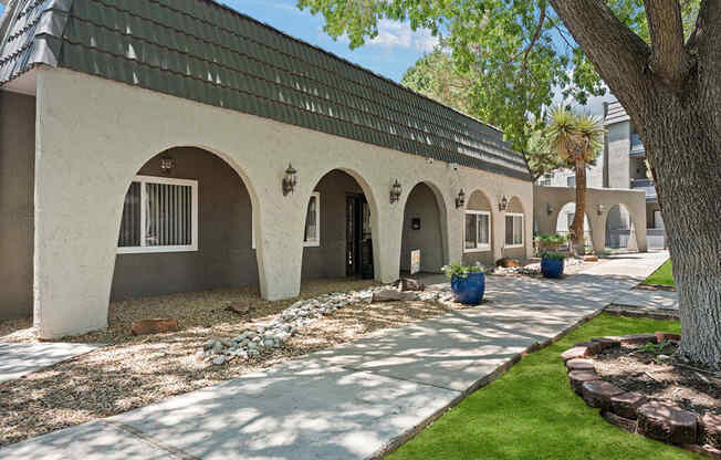 a building with a black roof and a courtyard