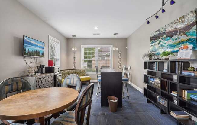 a dining room with a table and chairs and a living room with bookshelves