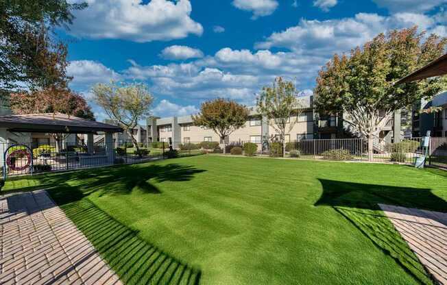 A grassy area with a building in the background.