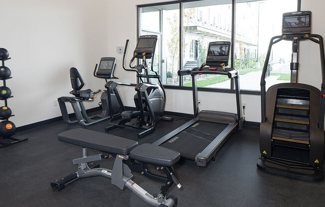 a gym with treadmills and other exercise equipment at The Landing at 1001 NP, Fargo, North Dakota, 58102