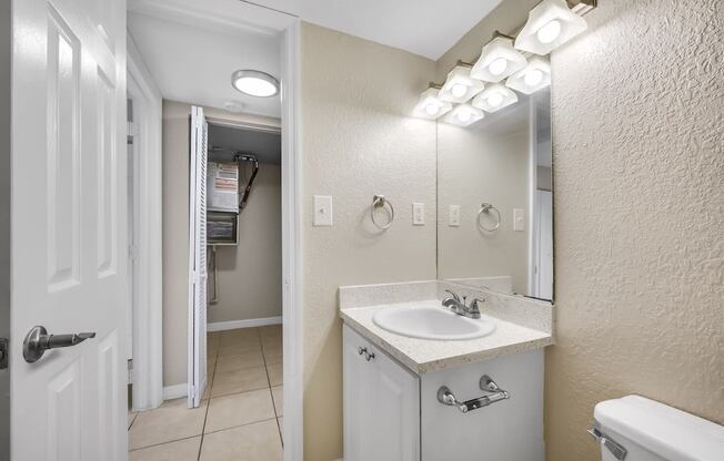 a bathroom with a sink and a mirror and a shower