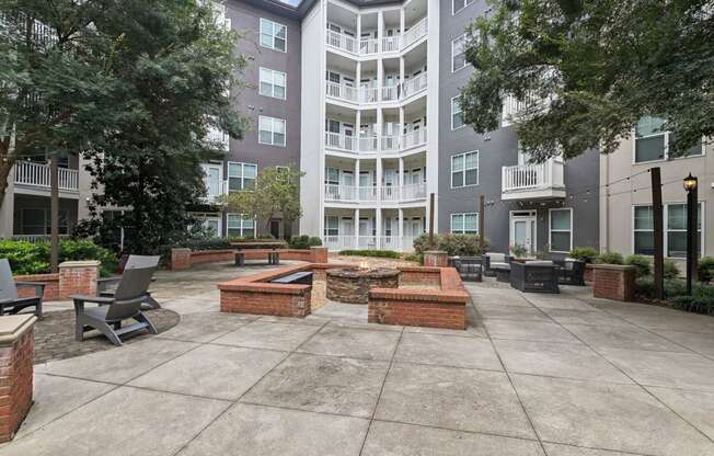 outdoor fireside lounging area with comfortable seating at Sorelle apartments