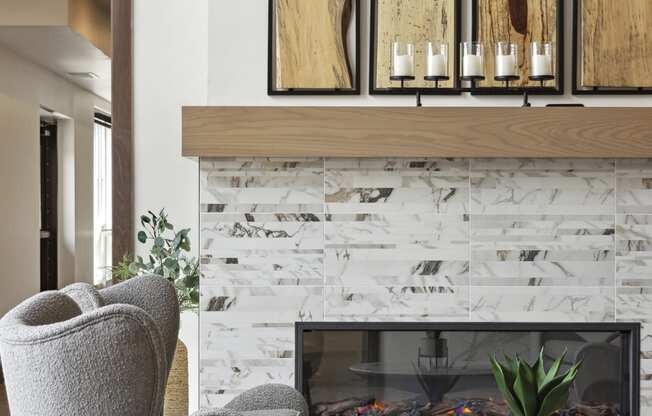 a living room with a fireplace and two chairs