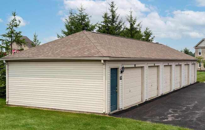 A long building with a blue door and a brown roof.