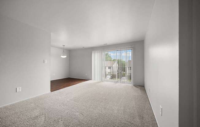Open and airy living room with natural lighting at Knottingham Apartments in Clinton Township, MI.