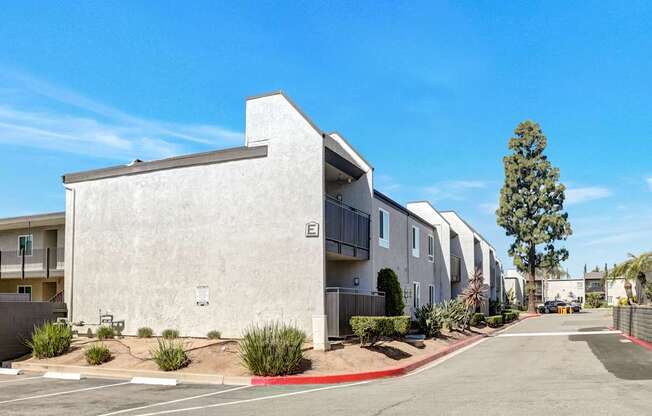 A row of modern apartment buildings with a clear blue sky above.