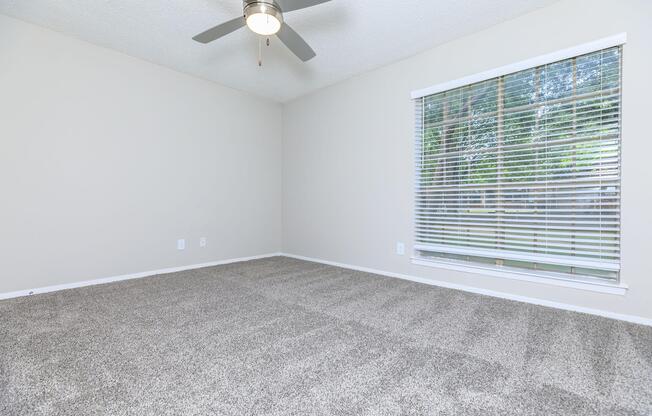 carpeted bedroom with a ceiling fan